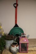 A garden rake and shovel, plastic Christmas tree stand, galvanized bucket and watering can, lantern,