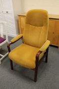 A late 20th century stained beech manual reclining armchair