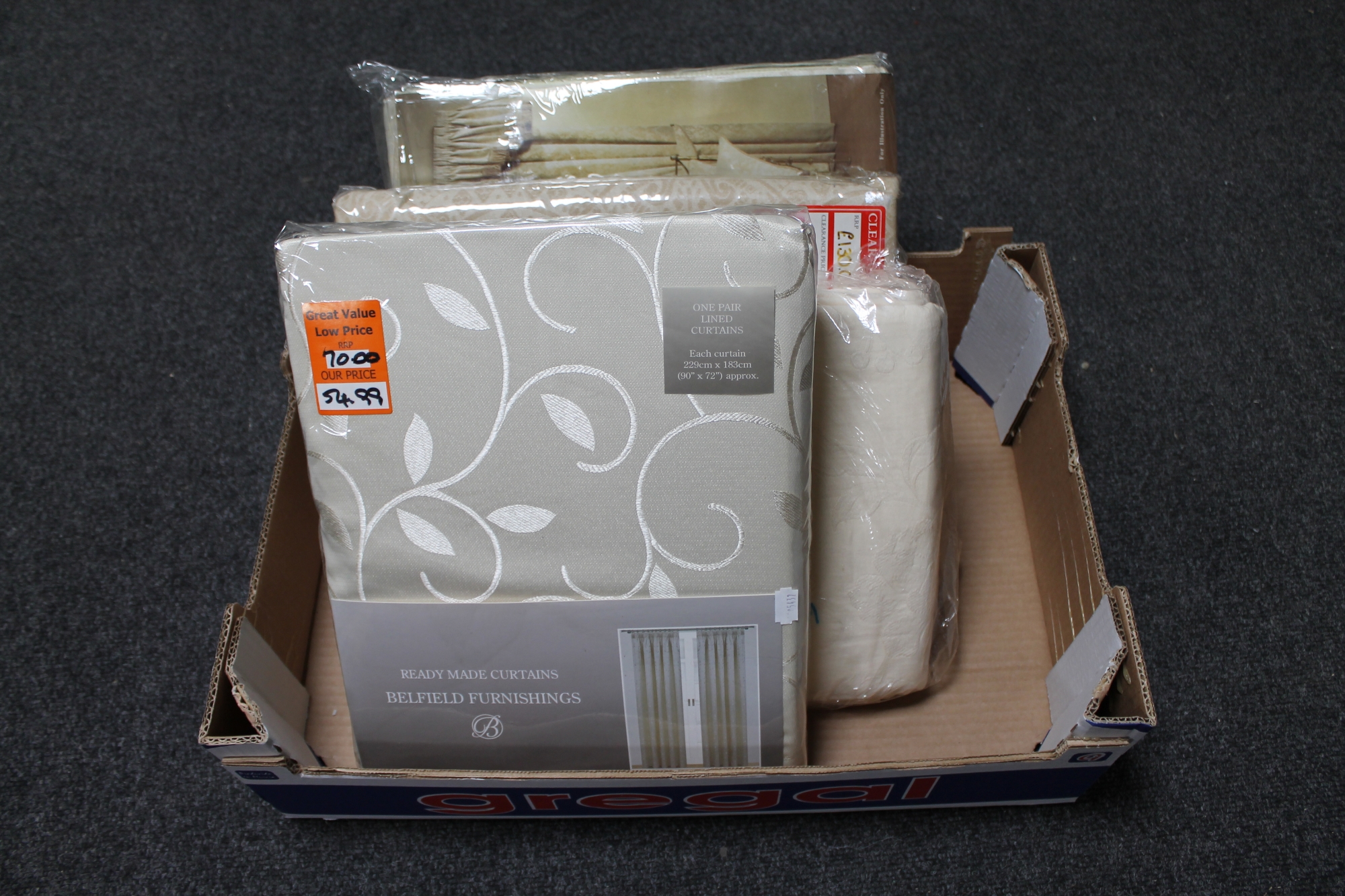 A box of four new pairs of curtains