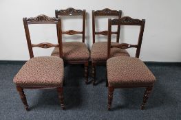 A set of four carved Edwardian mahogany dining chairs
