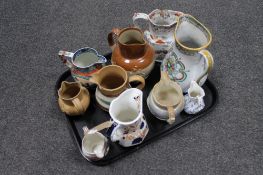 A tray of ten antique pottery jugs