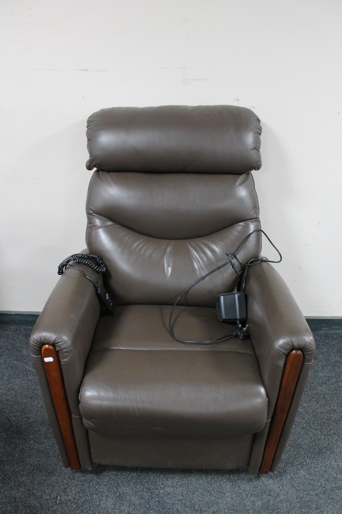 A brown faux leather electric reclining armchair.