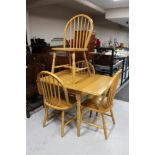 A plantation rubber wood drop leaf kitchen table and four chairs