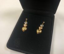 A pair of 10ct three-tone gold drop earrings with post fittings