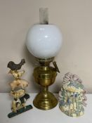 A brass Duplex oil lamp with chimney and shade together with two cast iron door stops