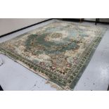 A Chinese floral embossed fringed carpet on green ground, approx. 300 cm 450 cm (excluding fringe).