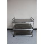 A stainless steel three tier prep trolley (no castors).