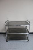 A stainless steel three tier prep trolley (no castors).
