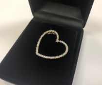 A silver heart pendant set with diamonds