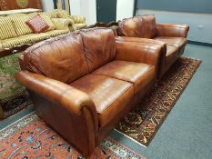 A pair of two seater brown leather settees,