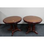 A pair of reproduction pedestal lamp tables.