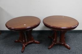 A pair of reproduction pedestal lamp tables.