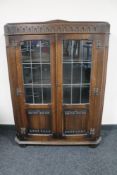 An early 20th century oak linen fold bookcase.