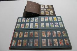 Three albums of cigarette cards including Wills,