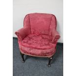 A 20th century armchair in red brocade.