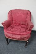 A 20th century armchair in red brocade.
