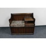 An oak telephone seat with tapestry cushion