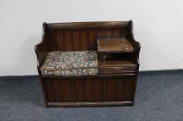 An oak telephone seat with tapestry cushion