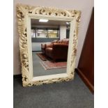 An ivory coloured framed mirror