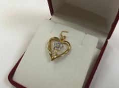 A 10ct yellow gold floral diamond and tanzanite pendant CONDITION REPORT: 2.5g.