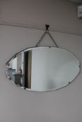 An Art Deco frameless bevelled mirror together with a metal skillet