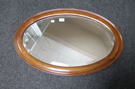 An oval mahogany wall mirror