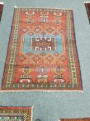 A Caucasian rug on red ground,