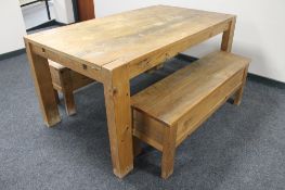 A pine kitchen table and two pine storage benches.