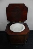 A Victorian mahogany commode on scroll legs.