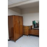 A four piece mid 20th century teak bedroom suite : double door wardrobe, five drawer chest,