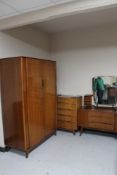 A four piece mid 20th century teak bedroom suite : double door wardrobe, five drawer chest,