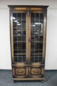 An Edwardian oak double door bookcase.