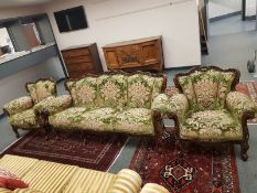 A continental carved three piece lounge suite comprising three seater settee (width 200 cm) and two