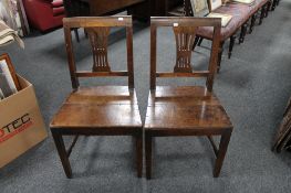 A pair of early Victorian oak dining chairs.