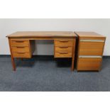 A mid 20th century teak twin pedestal writing desk and teak filing chest.