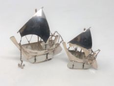 Two Arabian silver models of sailing ships, or Dhows, on stands, with moveable anchors and rudders,