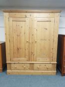 A good quality pine double door wardrobe, fitted with two drawers,