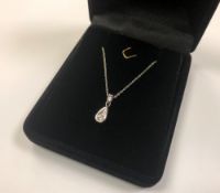 A 14ct white gold diamond set pendant on 10ct gold chain