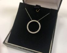 A 10ct white gold diamond set circular pendant on chain CONDITION REPORT: 1.9g.