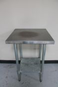 A square stainless steel two tier prep table