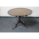 An antique mahogany tilt topped coffee table on tripod base.