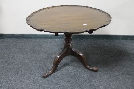 An antique mahogany tilt topped coffee table on tripod base.