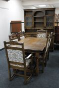 An eight piece Old Charm dining room suite comprising dresser, refectory table and six chairs.
