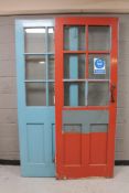 A pair of painted early 20th century interior school doors with six glass inset panels