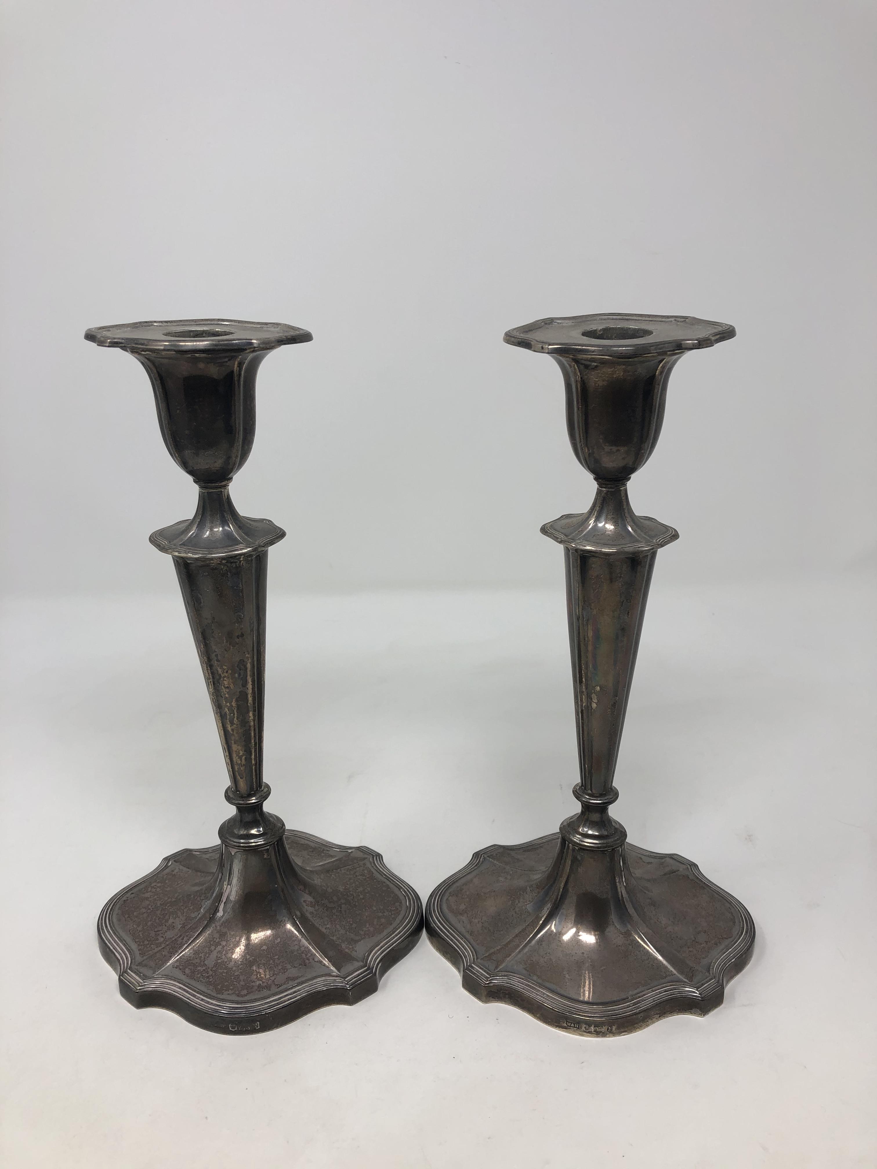 A pair of loaded silver candlesticks, Walker & Hall, Sheffield, with sconces, height 23.5cm.