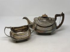 A Georgian silver three piece tea set comprising teapot, milk jug and sugar bowl, maker WB,