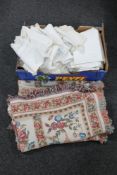 A box of a quantity of embroidered table linen and two fringed tapestry throws