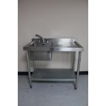 A Vogue stainless steel two tier sink unit with sink and drainer.