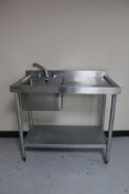 A Vogue stainless steel two tier sink unit with sink and drainer.