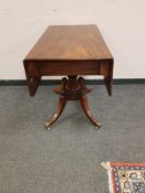 A 19th century flap sided pedestal table,